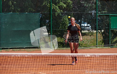 Image of A young girl showing professional tennis skills in a competitive match on a sunny day, surrounded by the modern aesthetics of a tennis court.