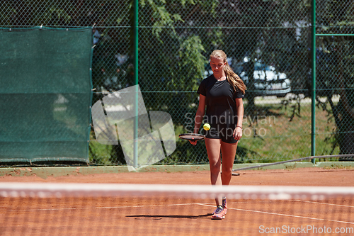 Image of A young girl showing professional tennis skills in a competitive match on a sunny day, surrounded by the modern aesthetics of a tennis court.