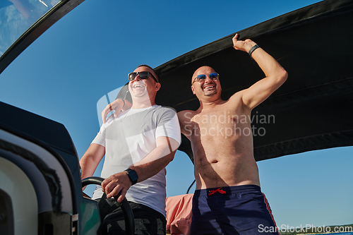 Image of Friends on luxurious yacht on the open sea, relaxing in the warmth of the sun, as they enjoy a day filled with adventure and friendship.