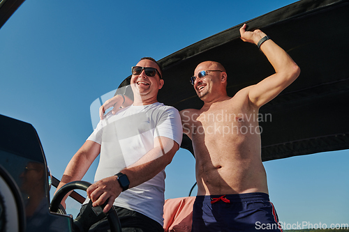 Image of Friends on luxurious yacht on the open sea, relaxing in the warmth of the sun, as they enjoy a day filled with adventure and friendship.