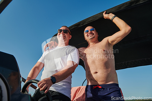 Image of Friends on luxurious yacht on the open sea, relaxing in the warmth of the sun, as they enjoy a day filled with adventure and friendship.