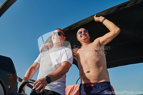 Image of Friends on luxurious yacht on the open sea, relaxing in the warmth of the sun, as they enjoy a day filled with adventure and friendship.