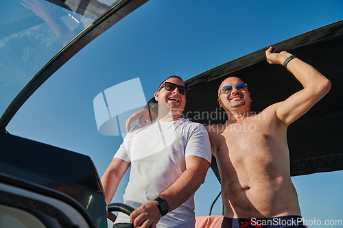Image of Friends on luxurious yacht on the open sea, relaxing in the warmth of the sun, as they enjoy a day filled with adventure and friendship.