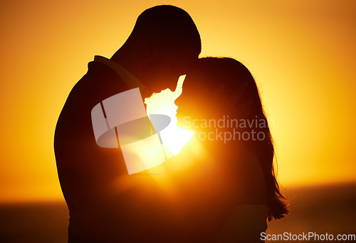 Image of Silhouette, sunset and couple on honeymoon love bonding, hugging and enjoying quality time together in Los Angeles. Romantic woman and partner on holiday vacation in a dark night on Valentines day