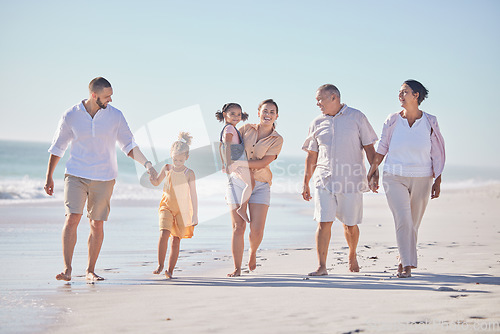 Image of Family, love and beach with a girl, grandparents and parents walking on the sand with a view of the sea or ocean and sky. Love, travel and summer with a man, woman and daughter happy on vacation