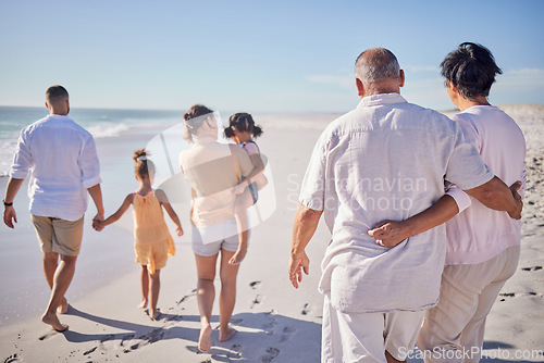 Image of Big family at beach, relax on summer vacation with grandparents and kids at the sea. Retirement time together, quality travel in the sun and enjoy a holiday by the ocean. Sand, sunshine and fresh air