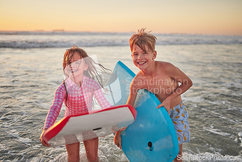 Image of Happy children, beach and learning to surf for fun and bonding on bali summer vacation. Kids, boy and girl siblings on tropical holiday while surfing with board for water sports, splash and swim