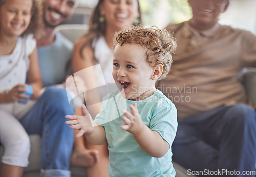 Image of Baby, clapping hands and excited toddler boy feeling happy, playful and cheerful at home with his family showing growth, development and having fun. Cute child playing in his new Zealand house