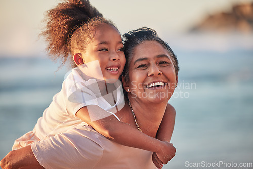 Image of Family, children and beach with a girl and grandmother outdoor by the sea or ocean during summer. Happy, smile and face with a woman and granddaughter spending time outside together in nature