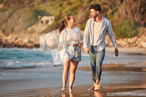 Image of Love, travel and happy with couple at the beach holding hands on Cancun summer vacation for relax, peace and support. Sunset, ocean and smile with man and woman walking on Mexico holiday together