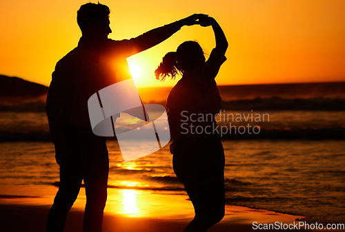 Image of Sunset, dance and silhouette of couple by the beach together for love, travel and Puerto Rico holiday. Summer, sunrise and nature with man and woman dancing by the sea for vacation, happy and relax