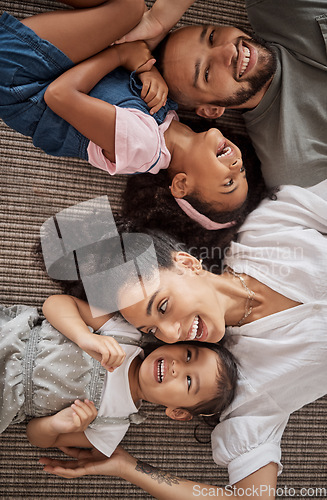Image of Love, above and happy relax family having fun, bond or enjoy quality time together in home living room. Smile, laugh and happiness for youth kids or children with mom, dad or parents on the floor