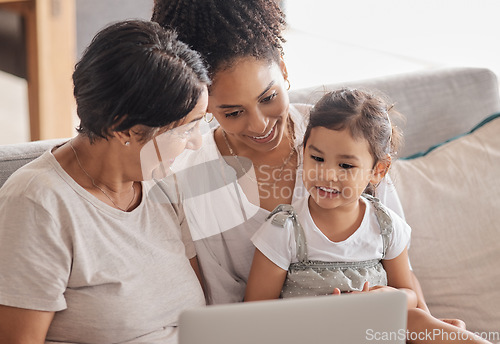 Image of Children, family and laptop with a girl, mother and grandmother using the internet on a sofa in a living room. Adoption, foster care and love with a woman, daughter and child watching series together