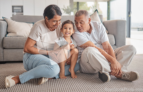 Image of Grandparents, little girl and love in relaxing bonding time together in the living room at home. Portrait of happy child smiling in loving, fun relationship with grandma and grandpa relaxing on floor