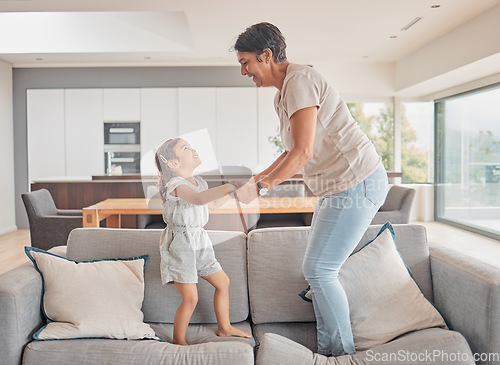 Image of Grandma jump and girl on sofa in fun play, happy together and excitement at home. Happy energetic family playing on couch excited in joyful entertainment for free time leisure with smile and love