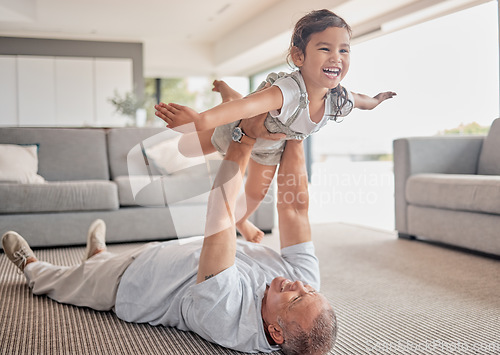 Image of Love, happy grandfather and girl play in living room and laugh, fun and smile together. Grandparent lifting grandchild at home in lounge and enjoy bonding, carefree and relax on floor on weekend.