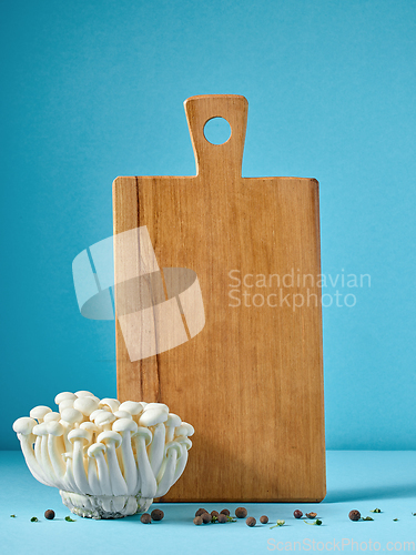 Image of wooden cutting board and mushrooms