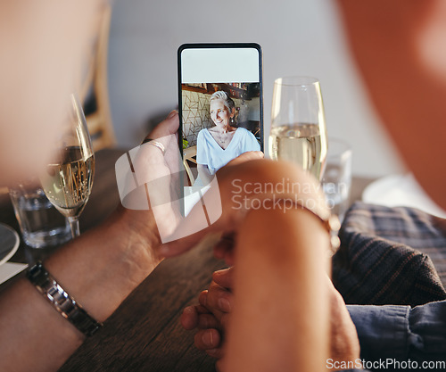 Image of Phone, image and vacation memories with senior couple drinking champagne sitting at table at restaurant looking at picture gallery on social media. Happy senior woman on smartphone screen on holiday