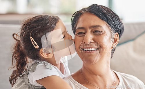 Image of Love, family and kiss with girl and grandma together for happy, retirement or mothers day celebration. Smile, hug and proud with child and grandmother at home in embrace for birthday or care