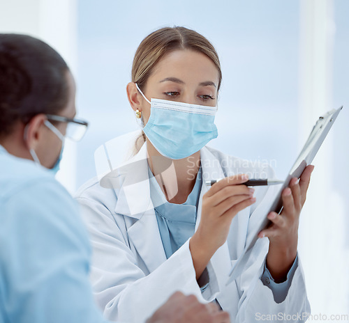 Image of Consulting, patient and doctor with mask and documents about health, chart and results. Health, covid and physician helps patient with vaccine forms, pandemic safety regulations or rules at hospital