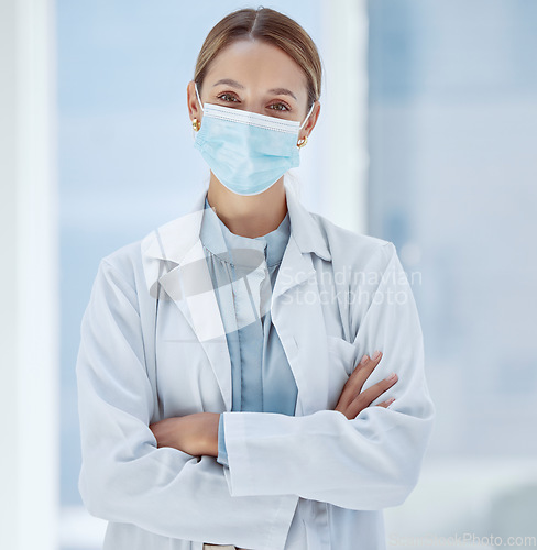 Image of Woman, healthcare and covid face, mask rules with proud doctor working in a hospital, ready and confident. Health care professional leader work during pandemic, focused on helping sick people