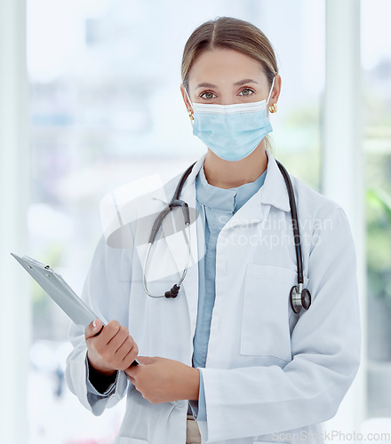 Image of Medical doctor in covid hospital portrait, health safety compliance and healthcare professional woman with face mask. Expert consultation, clinical medicine work and clipboard examine virus results