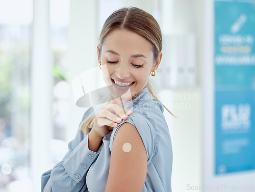 Image of Covid, vaccine and plaster with a healthcare woman in a hospital after getting a shot, booster or medical injection. Injection, immunity and medicine with a female getting vaccinated in a clinic