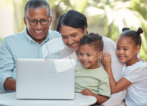 Image of Grandparents, children and laptop on video call with family in house garden or home backyard. Smile, happy and kids with senior man and woman bonding with communication technology for movie streaming