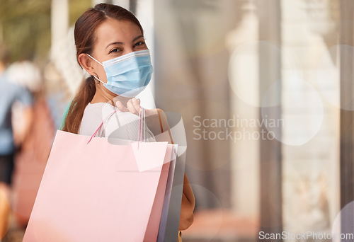 Image of Shopping, medical mask or portrait of woman with shopping bags, smile or happy sale luxury designer clothes. Covid, rich customer or Asian girl with retail discount, fashion or store sales in street