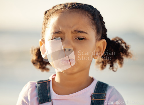 Image of Portrait, sad and face of an unhappy little girl feeling lonely or upset against a blurred background. Closeup of an emotional African female child with depressed facial expression for end of summer