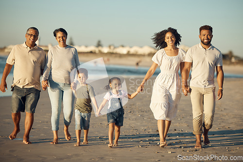 Image of Family on beach with children smile while parents, kids grandparents holding hands on vacation by the ocean. Black family walking in sand by the sea, show love and bonding on holiday or reunion