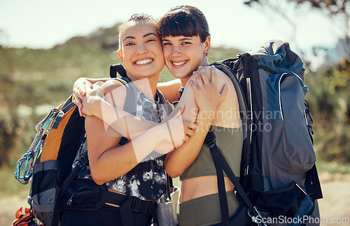 Image of Women mountain hiking, friends hug in nature and outside in summer sun freedom. An adventure hike is great for exercise, fitness training and cardio with friend on hills of a local natural landscape