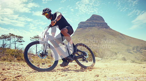 Image of Mountain bike, fitness and exercise man off road, dirt road or sand by Lions head mountain. Health, wellness and male on desert, dust or terrain track on bicycle training for cycling race in nature.