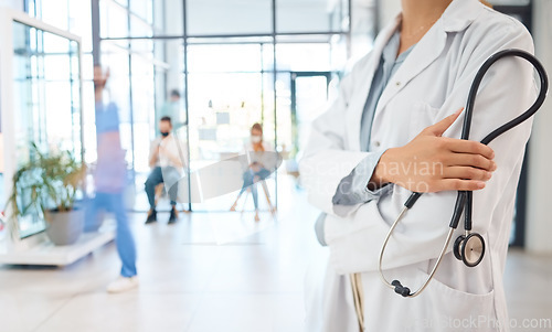 Image of Medical healthcare doctor, woman worker or employee arms crossed confident with stethoscope in busy hospital. Leadership, work or wellness female staff manager nurse working in medicine clinic office