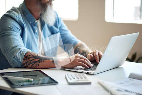 Image of Businessman, tattoo and digital marketing laptop with startup company finance, budget or office paper data. Ceo hands, leadership or thinking manager working on technology with brand growth documents