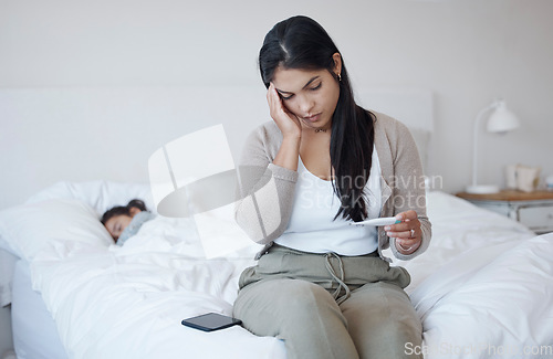 Image of Woman, covid and thermometer on bed with headache in concern, doubt and stress for illness at home. Depressed, worried and sick female checking temperature or fever in mental health issues in bedroom