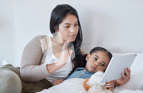 Image of Mother and sick child, video call and with tablet for telehealth online consultation for daughter lying in bed. Serious woman and kid in bedroom greeting with 5g network communication for healthcare