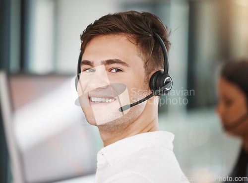 Image of Portrait of a call center consultant working in an office doing a crm strategy with headset. Happy, professional and young telemarketing agent doing ecommerce sales and customer support operation.