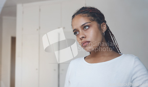 Image of Sad, thoughtful and depressed woman in her home feeling alone and isolated. Mock up for depression, sadness and mental health issues. Thinking, worried and upset young girl with problems in her room