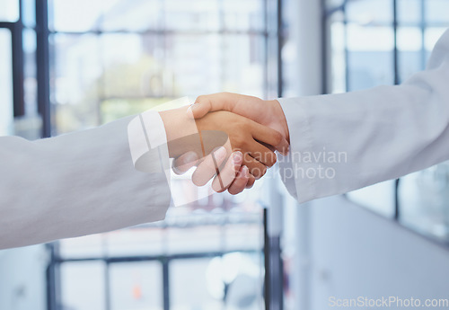 Image of Doctors meeting, shaking hands and partner at hospital with lab coats. Scientist or doctor agree on medical business, support and cooperate together with handshake to show collaboration and teamwork