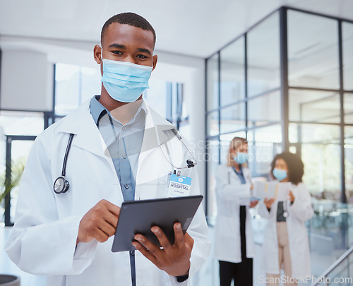 Image of Portrait of doctor with mask and tablet during covid for bacteria, medicine or corona virus research. Safety, protection and black medical healthcare worker or hospital employee doing telehealth work