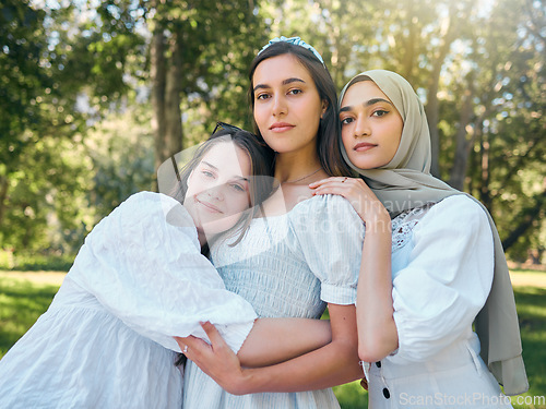 Image of Group of women hug, show diversity, support and solidarity together, against forrest or garden background. Multicultural friends stand in unity, in outdoor portrait with trees or woods in backdrop