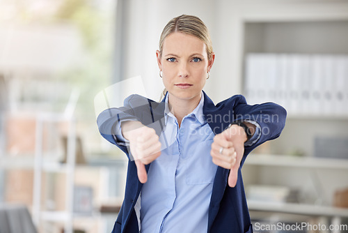 Image of Business woman, thumbs down and hands in failure, loss or disappointed at work in the office. Portrait of a corporate female employee in disagreement, reject or disapproval gesture at the workplace