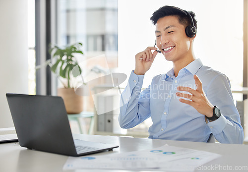 Image of Customer service, call center and telemarketing with an asian man consultant working on a laptop with a headset. Contact us, crm and consulting with a male working in his sales office with a smile