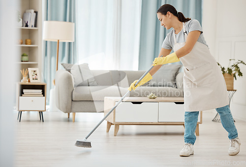 Image of Cleaning, asian girl and sweeping floor with broom for home interior spring clean tidy habit. Housekeeping woman busy with housework in apartment living room for good hygiene lifestyle in house.