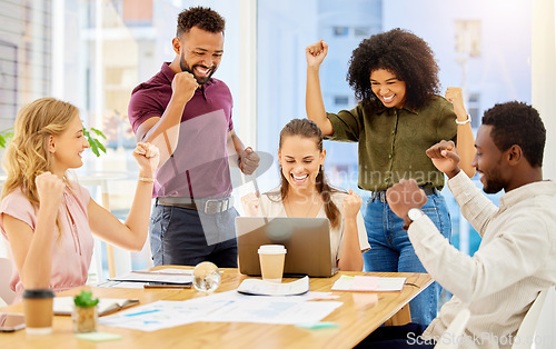 Image of Happy team celebrate success, sales target business meeting with laptop and staff teamwork goal achievement. Young casual people smile, group working collaboration and company pride in victory fist