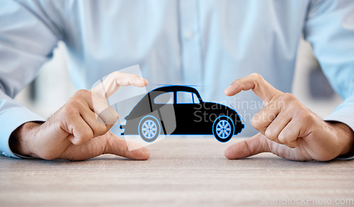 Image of Man with model car in hands, promote business of insurance or vehicle finance at table in office. Businessman show toy auto, to advertise sale or motor repair workshop on desk at work or home