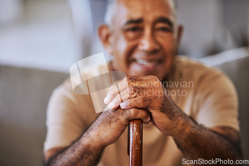 Image of Portrait of a happy, kind black senior man hands with wrinkles, holding a walking stick and smiling in a retirement home sitting on outside relaxing and waiting in the queue