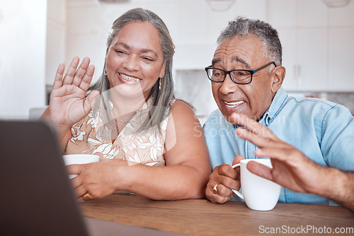 Image of Laptop, video call and senior couple wave at friends and family while drinking coffee together at a table. Lockdown, communication and elderly man and woman enjoy online conversation in their home