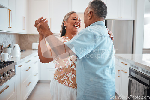 Image of Happy senior couple, dance and laughing in joyful happiness for relationship bonding in the kitchen at home. Elderly man and woman with smile dancing together for romantic moment in love and care